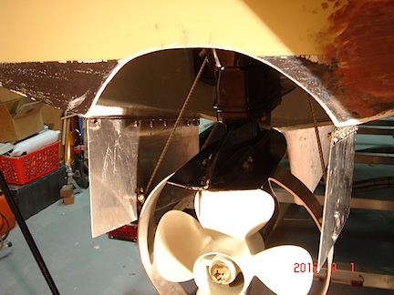 Bomb-bay doors close the motor well when the outboard is retracted. The guard around the propeller pushes the doors open when the motor is lowered.